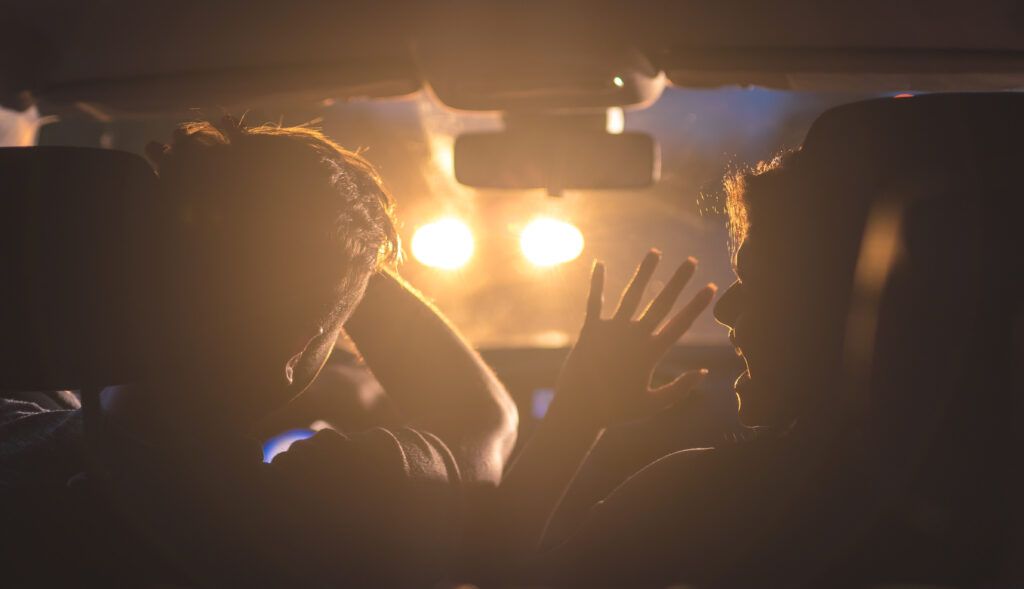 The man and woman drive a car in emergency situation. evening night time